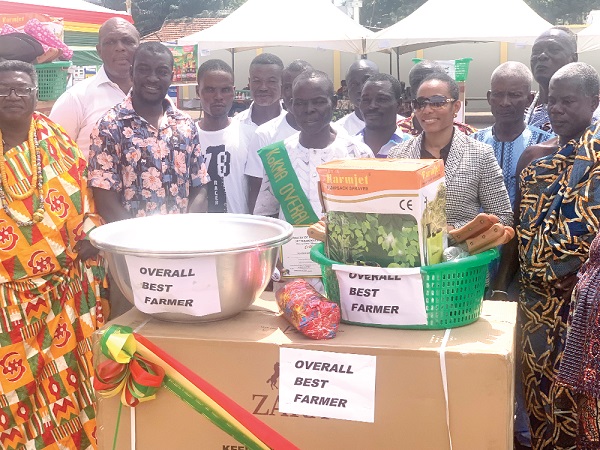 Image of Dr Zanetor Agyeman-Rawlings (2nd from right) with Stephen Nartey (3rd from right), the KoKMA best farmer, and his family at the event