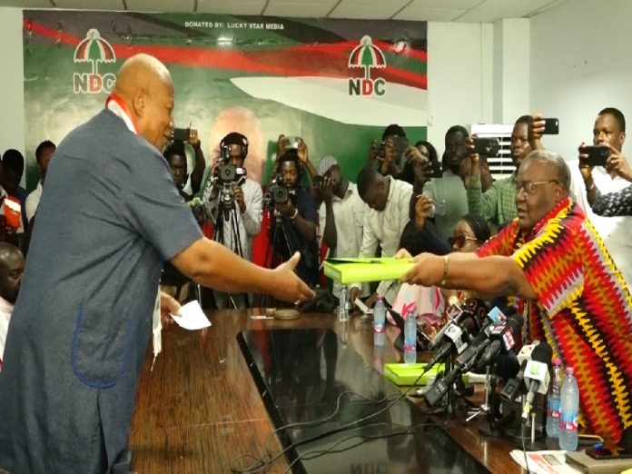 Image of Prof Alabi (left) receives Mahama's forms at the party HQ in Accra