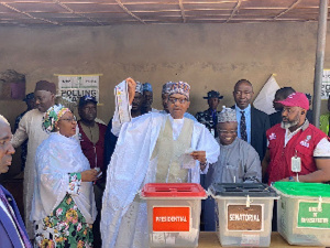 Image of President Muhammadu Buhari, his wife casting their ballot