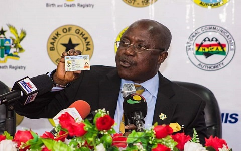 Image of NIA boss, Professor Ken Attafuah holding a Ghana Card