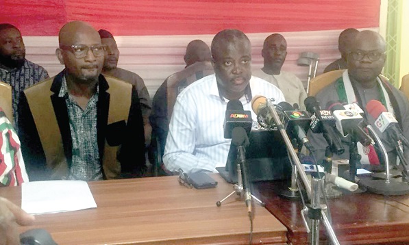 Image of Prof. Richard Asiedu (middle), NDC Central Regional Chairman, addressing the press conference. With him are some senior members of the party in the region